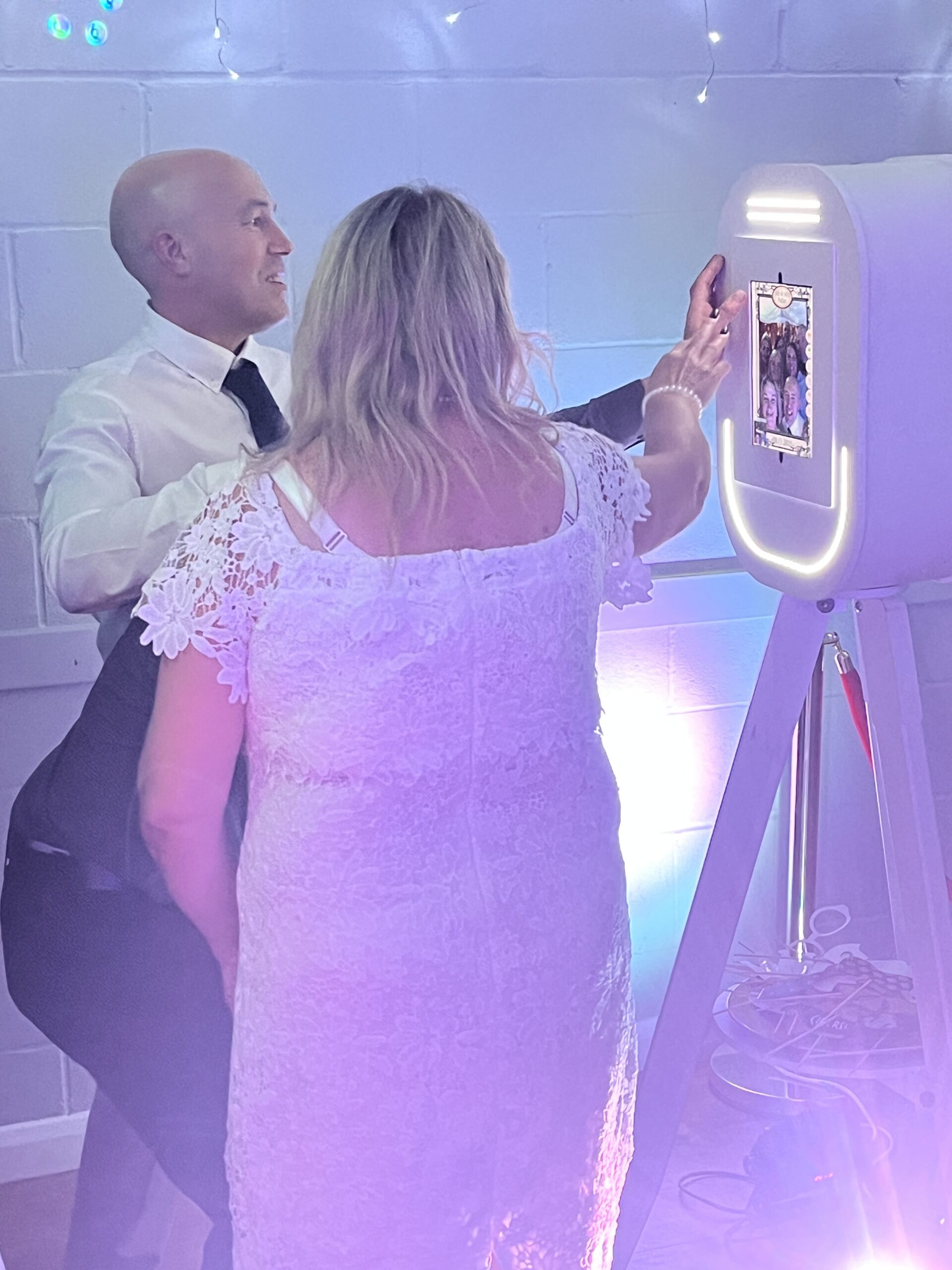 Wedding guests using the Selfie Pod photo booth in Norfolk